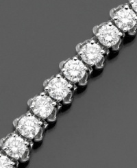 Elevate elegance with a seemingly endless display of diamonds. This beautiful diamond bracelet features round-cut diamonds (6 ct. t.w.) set in 14k white gold. 6 carat diamond bracelet approximate length: 7 inches.