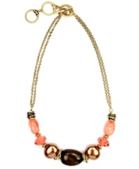 A cool splash of color. Jones New York's double strand necklace incorporates coral and shimmery beige-colored acrylic beads secured by a toggle clasp. Crafted in gold-plated mixed metal. Approximate length: 17 inches + 2-inch extender.