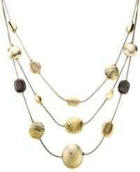 Fashion that works like magic. Alfani's illusion necklace features three rows of circular pendants in gold and hematite tones. Crafted in gold tone mixed metal. Approximate length: 18-5/8 inches + 3-inch extender. Approximate drop: 2-3/8 inches.