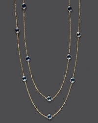 Round checkerboard blue topaz stations gleam on a long, loopable 14K yellow gold chain.