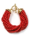 Make a bold, beaded statement with this multi-strand bracelet from Carolee, dripping in coral-colored beads.