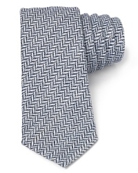 Herringbone gets a modern update on this skinny width tie, the perfect complement to your contemporary dress shirting.