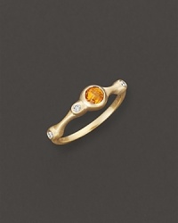 A faceted orange citrine and brilliant diamonds add bright color to gleaming 18K yellow gold. By Carelle.