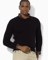 A refined crewneck sweater is knit from sumptuously soft cashmere for a handsome, preppy look.