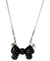 Tie this on for size. This polka dot bow pendant from Betsey Johnson makes a fun statement. Crafted from antique gold-tone mixed metal with added black tones, the necklace also features a glass pearl accent for a stylish touch. Item comes packaged in a signature Betsey Johnson Gift Box. Approximate length: 16 inches + 3-inch extender. Approximate drop: 1 inch.