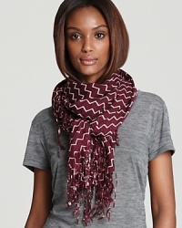 A new take on zig-zag: Tory Burch adds signature Ts to the punchy pattern of this wool scarf.