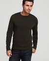 A Victorinox crewneck sweater features shoulder and elbow patches, reinforcing a refined military-inspired look.