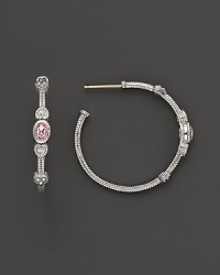 Faceted, oval-shaped pink crystals, flanked by hearts, bring romantic glamour to classic sterling silver hoop earrings.