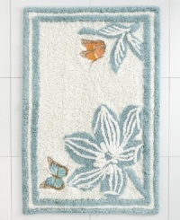 A lovely floral motif in a serene blue and white palette lends an air of nature-inspired sophistication to this Martha Stewart Collection Mariposa bath rug. A smattering of fanciful butterflies add delightful pops of color.