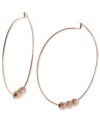 Michael Kors adds an elegant touch to its pair of hoop earrings. Crafted from rose gold ion-plated mixed metal, the earrings feature glass pave fireballs for a lustrous touch. Approximate diameter: 2 inches.