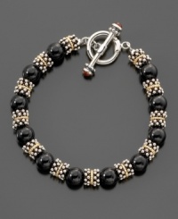 A dramatic accent for any occasion, this bracelet features black onyx stones (8.5-9mm) surrounded by sterling silver beads and 14k gold accents. Measures 8 long.