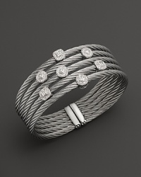 Diamonds set in white gold on a stainless steel bangle. By Charriol.