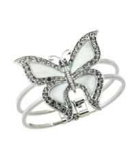 It's high-time to let your style soar. GUESS bracelet highlights a large butterfly with Mother of Pearl wings edged with sparkling, round-cut crystals. Crafted in silver tone mixed metal. Approximate diameter: 2 inches.