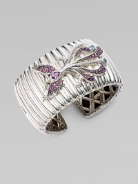 A substantial textural cuff adorned with a bird encrusted in amethyst, rhodolite and Swiss blue topaz. Sterling silver Amethyst Rhodolite Swiss blue topaz Kick mechanism closure Diameter, about 2½ Width, about 1½ Imported 