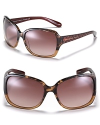 Fall in love with these oversized two-color sunglasses with goldtone glitter heart embellishments along arms.