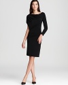 Armani Collezioni updates the all-essential LBD with asymmetric sleeves and a draped silhouette for a fashion-forward look. Team with sleek pumps for minimalist chic.