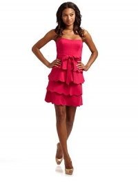 This stunning ponte frock with tiers of scallop ruffles at the skirt and a long sash at the waist, is an easy head-turner.Strapless neckline Seamed bodice with boning Belt loops with waist sash Side zipper Tiers of scalloped ruffles at waist Fully lined About 25 from shoulder to hem 69% rayon/26% nylon/5% spandex Dry clean Imported