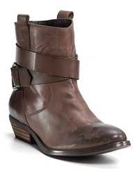 A buckle strap winds around the ankles of these booties, adding a hint of tough to the polished leather. By Aqua.