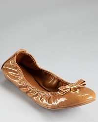 In a flexible silhouette, Tory Burch's slick Eddie flats are dressed up with a ladylike bow and iconic logo.