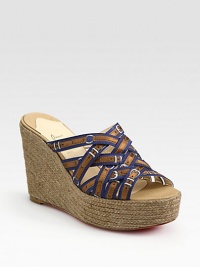 Grounded by a chunky espadrille wedge, printed silk straps take on a buckle-like form. Hemp wedge, 4 (100mm)Hemp platform, 1½ (40mm)Compares to a 2½ heel (65mm)Printed silk upperLeather liningSignature red leather solePadded insoleMade in SpainOUR FIT MODEL RECOMMENDS ordering one half size up as this style runs small. 