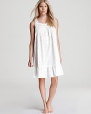 All-over embroidery and floral-shaped buttons lend charm to this white sleeveless nightgown from Eileen West.