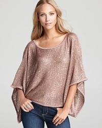 Dripping with dazzling sequins, a Shiloh770 sweater steals the spotlight with statement batwing sleeves.