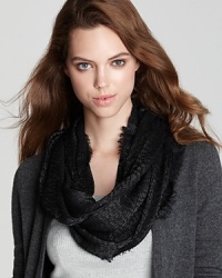 Dazzling day or night, Echo's sparkly circle scarf adds radiance to solid sweaters and coats.