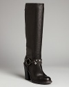 Vera Wang lends refined tall boots a bit of rocker edge-when the mood strikes-in the form of removable studded harnesses. Wear these basic black boots to work, slip the studs on after hours.