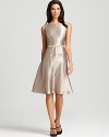 A swing skirt lends a ladylike look to this belted Anne Klein dress, rendered in a shimmering metallic fabric.