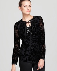 Bring some drama to your daily repertoire with this Tory Burch tunic, flaunting a lace-up neckline and a sheer burnout overlay for dark romance. Slip the style over leather leggings for a truly decadent look.