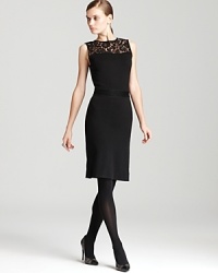 A sheer lace neckline lends dark romance to a classic Tory Burch dress for a demure yet dramatic look.