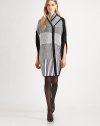 Geometric woven checks decorate this soft cocoon-style cape.Shawl collarAsymmetrical zip frontSide slitAbout 37 from shoulder to hem50% cotton/30% wool/20% polyesterDry cleanImportedModel shown is 5'9½ (176cm) wearing US size Small. 