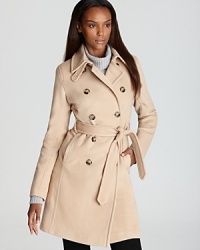 Shaped by darts and seaming detail, this DKNY trench coat is a polished layering piece for the cold-weather season, perfect for weekdays and weekends, days and evenings.