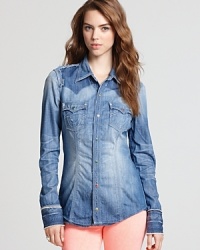 Country gal meets city slicker in this True Religion shirt. Classic denim boasts innovative distressed details for a look that's both casual and cool.