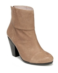 These VINCE CAMUTO booties subtly sum up the trends with a Western-style stacked heel and trend-right cap toe.