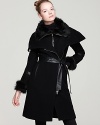 High drama marries pure luxe on this Mackage double-breasted wool coat embellished with plush fur collar and cuffs, a leather belt and arm bands, and shiny zips for downtown edge.