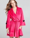 Bow down at bedtime in Betsey Johnson's velour robe with contrast bow and rosette details.