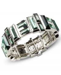 Green with envy. This Nine West bracelet showcases captivating plastic erinite stones set in a sleek setting. Stretches to fit wrist. Crafted in imitation rhodium tone mixed metal. Approximate diameter: 2 inches.