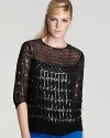 Sequins glitter in a intricate design sure to catch the light (and eyes) on this slouchy top from Nanette Lepore.