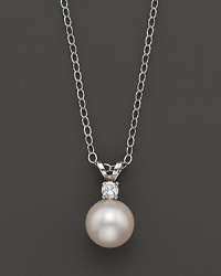 A cultured pearl pendant necklace on a chain.