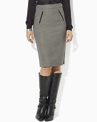 Look sophisticated and elegant at the office wearing a chic wool houndstooth pencil skirt, accented with faux-leather trim and equestrian details.