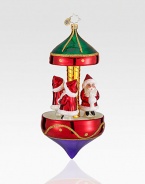 Miniature Santa figurines are set atop this glittery Christmas carousel. Hand-blownHand-painted6½ highMade in Poland