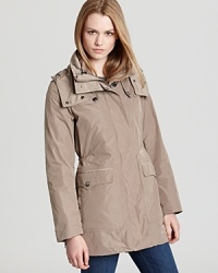 In a wear-with-all neutral, this utilitarian Burberry Brit anorak unzips to reveal an interior quilted jacket. Double up the layers or wear them solo--rain, sun or snow, this jacket promises a fashionable forecast.