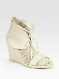 Urban-cool mesh design with a lace-up front and soft leather trim. Self-covered wedge, 3½ (90mm)Mesh and leather upperBack zipperLeather liningRubber soleMade in ItalyOUR FIT MODEL RECOMMENDS ordering one half size up as this style runs small. 