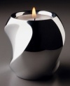 Light up your life with Nambe's twist votive candle holder. Its modern curved shape is rendered in alloy metal. Measures 3 inches tall.