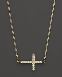 An elegant 14K. yellow gold cross, set with diamonds, on a slender chain. By Meira T.