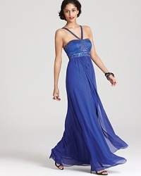 An elaborately beaded bodice tops off a flowing chiffon skirt on this potently hued Sue Wong gown.