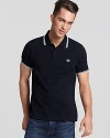 Widely known as the pioneer of Mod, British street fashion, Fred Perry polos have become an iconic fashion silhouette. A sporty polo with contrast double stripe trim and embroidered logo at left chest. Slim fit.