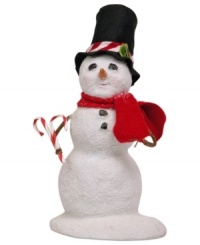 Sweetening the holiday season, this young snowman carries two candy canes to complement his hat. A red scarf completes his outfit from Byers' Choice.