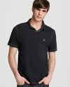 Give peace a chance in this calm, cool and collected polo from John Varvatos Star USA, detailed with contrast stitching for unique allover accents and tailored for a slim, modern fit.